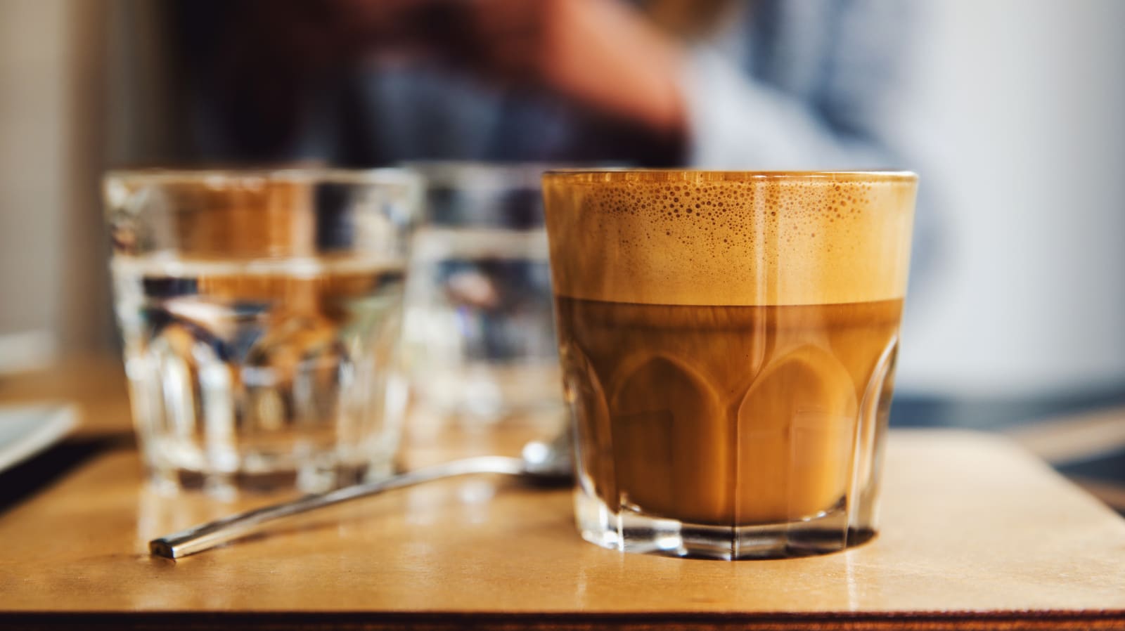 Cortado in a glass on a café table